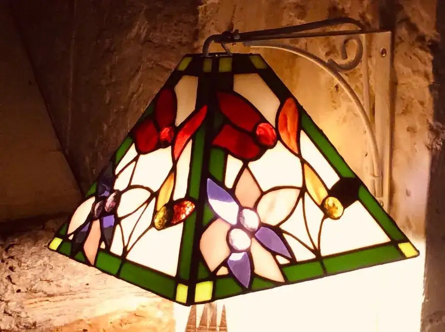 Handmade Tiffany lamp illuminated showing luminous light transmission and color play